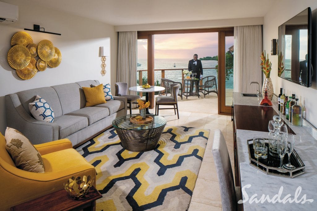 Sandals Negril suite with living area, ocean view, and butler on the balcony