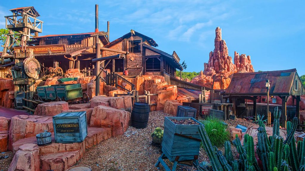 Big Thunder Mountain Railroad at Magic Kingdom with mountain rocks and night sky.